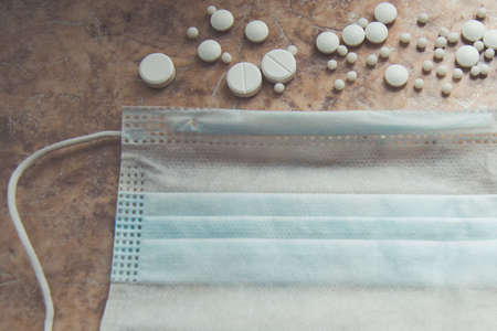The mask and tablets are on the table. Tools needed for the virus.の写真素材