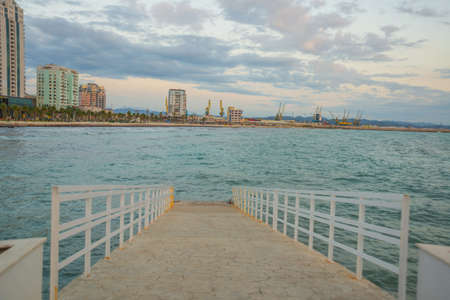 ALBANIA, DURRES: View from Cafe Ventus to the bridge and embankment with houses near the sea with birch water, Durres.の写真素材