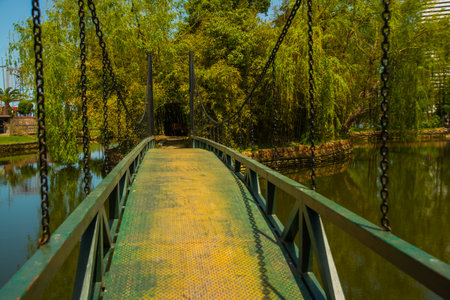BATUMI, GEORGIA: Beautiful metal bridge to a small island on a Ardagani lake in the park of Batumi, Adjara region of Georgia.のeditorial素材
