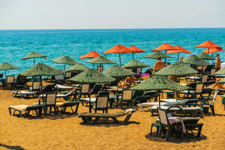 ANTALYA, TURKEY: Sun loungers and umbrellas on the Lara beach on a sunny summer day in Antalya, Turkey.のeditorial素材