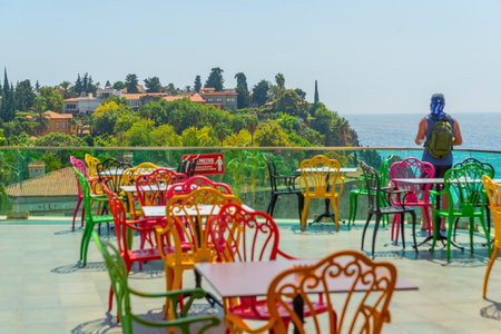 ANTALYA, TURKEY: Colorful chairs in the restaurant with a view of the sea and the old town. Beautiful top view of the cafe, the Mediterranean Sea and the mountains in Antalya, Turkey.のeditorial素材