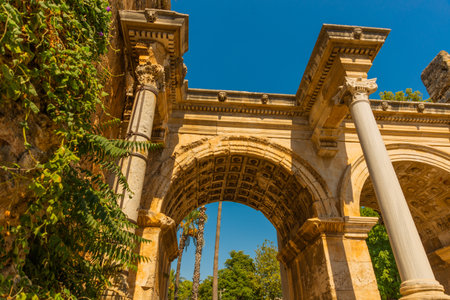 ANTALYA, TURKEY: Adrian Gate in the background blue sky. Antique ancient construction of marble and limestone, Antalya, Turkey.のeditorial素材