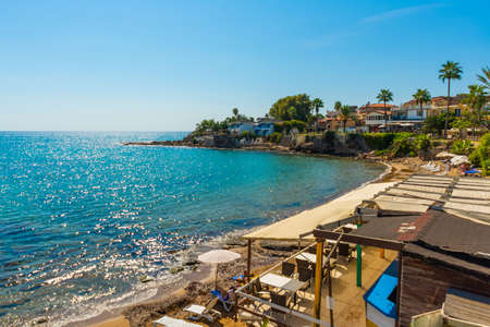 SIDE, TURKEY: View of the old Turkish houses on the street in the city of Side and the Mediterranean Sea on a sunny summer day in the background of the blue sky.の写真素材