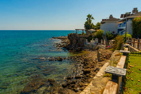 SIDE, TURKEY: View of the old Turkish houses on the street in the city of Side and the Mediterranean Sea on a sunny summer day in the background of the blue sky.の写真素材