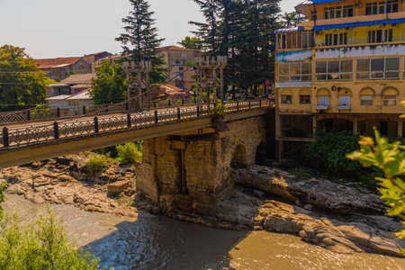 KUTAISI, GEORGIA: View of the Rioni River and the Chain Bridge in Kutaisi on a summer day.の写真素材