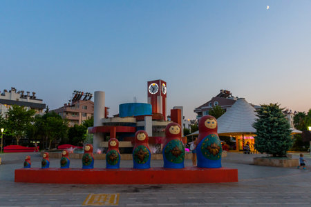 ANTALYA, TURKEY: A square with a clock tower, a fountain and a monument in the form of a matryoshka doll in Antalya in the evening.のeditorial素材