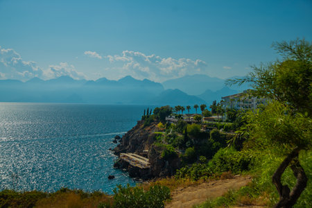 ANTALYA, TURKEY: View of a small beach in the rocks in the Turkish city of Antalya on a sunny summer day. Antalya is Turkey's biggest international sea resort located on Turkish Riviera.の写真素材