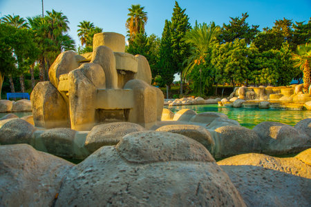 ANTALYA, TURKEY: Landscape with a view of a beautiful park with a fountain and a pond in the center of the Turkish city of Antalya on a sunny summer day.のeditorial素材