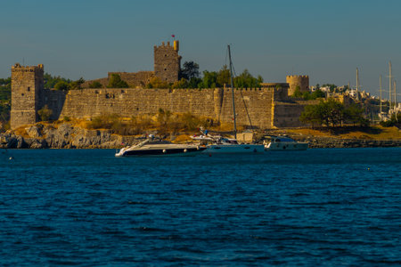 BODRUM, TURKEY: Landscape with a view of the Castle of St. Petra in Bodrum on a sunny day. Seascape with sailboats and luxury yachts in the harbor on the Aegean Sea in Bodrum, Turkey.のeditorial素材