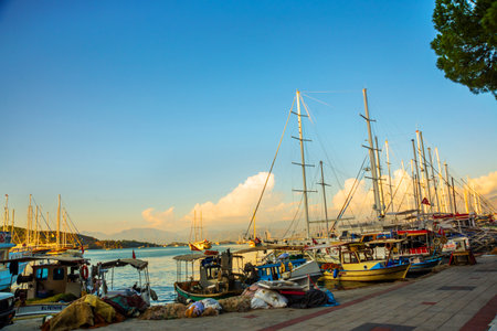 FETHIYE, TURKEY: View of the harbor with numerous yachts, and beautiful mountains in the background in the rays of the sunのeditorial素材