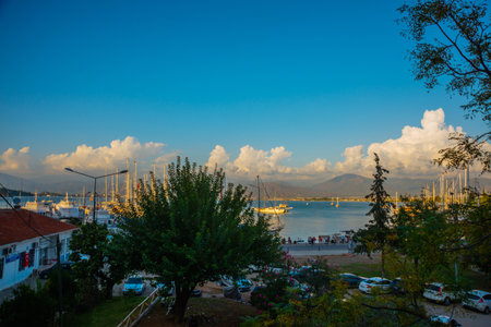 FETHIYE, TURKEY: View of the harbor with numerous yachts, and beautiful mountains in the background in the rays of the sunのeditorial素材