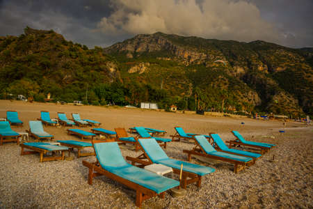 OLUDENIZ, FETHIYE, TURKEY: Beautiful landscape with Sun Loungers on Oludeniz beach in cloudy. Oludeniz beach is best beaches in Turkey.の写真素材