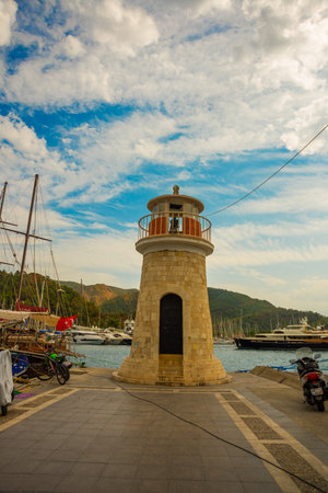 MARMARIS, MUGLA, TURKEY: View of the lighthouse at the berth of ships and yachts in Marmaris on a cloudy day.のeditorial素材