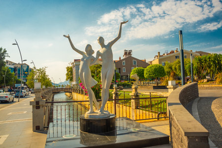 MARMARIS, MUGLA, TURKEY: Sculpture of a man and a woman by the canal in the center of Marmaris in sunny dayのeditorial素材