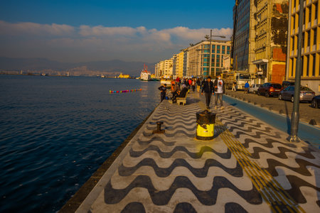 IZMIR, TURKEY: Promenade with sea view and traditional pattern on the road in Izmir on a cloudy day.のeditorial素材