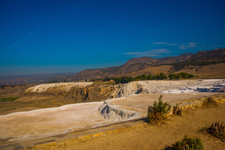PAMUKKALE, DENIZLI, TURKEY: Beautiful landscape with panoramic views of the white travertine and the mountains on a sunny day.のeditorial素材