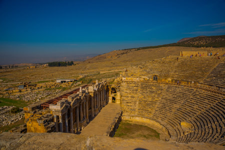 PAMUKKALE, DENIZLI, TURKEY: Antique Amphitheater in Pamukkale on a sunny day in the background of a...