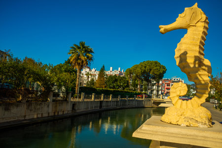 MARMARIS, MUGLA, TURKEY: Sculpture of a Seahorse and a Frog on the street by the canal in Marmaris on a sunny day.のeditorial素材