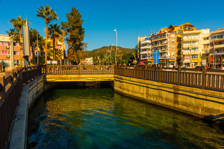 MARMARIS, MUGLA, TURKEY: Canal with water on the street of the city of Marmaris on a sunny day.のeditorial素材