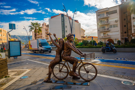 MARMARIS, MUGLA, TURKEY: A modern monument of a guy and a girl riding a bicycle on the street in Marmaris.のeditorial素材
