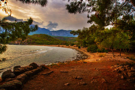 PHASELIS, TURKEY: Beautiful view from the beach to the sea and mountains in the ancient city of Phaselis at sunset in the village of Tekirova, Antalya province, near Kemer, Turkey.の写真素材