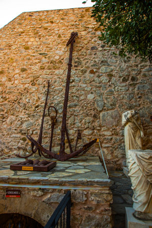 MARMARIS, MUGLA, TURKEY: Antique fragments of sculpture and anchor in the fortress Museum in Marmaris on a sunny day.のeditorial素材