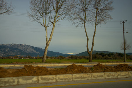 MUGLA, TURKEY: Beautiful Landscape with mountain view in snow and green grass in Mugla on a cloudy day.のeditorial素材