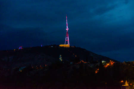 TBILISI, GEORGIA: TTV tower on the mountain at night in Tbilisi in summer