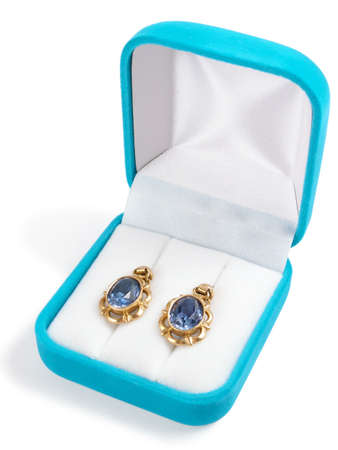 Photo of ear-rings with dark blue stones in a box.の写真素材