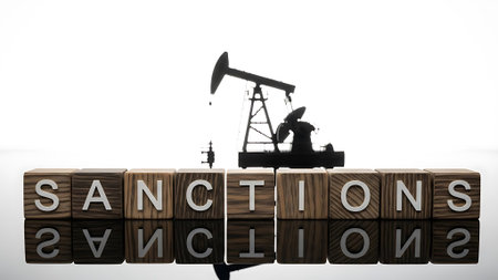 The word Sanctions on wooden cubes with the image of the oil pump and oil derrick on a white backgroundの素材