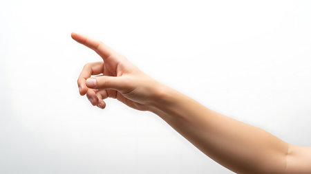 Female hand pointing at something isolated on white background. Close up.の素材