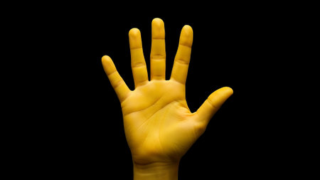 Yellow hand isolated on black background with clipping path. Front view.の素材