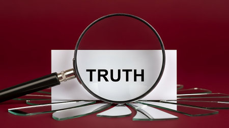 Magnifying glass focusing on 'TRUTH' card with broken glass pieces scattered around.の素材