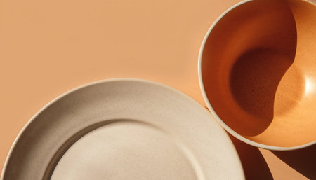 A still life of two ceramic dishes against a solid colored backdrop.の素材