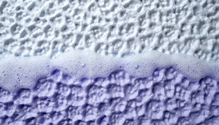 Soap suds on a textured surface, showcasing the intricate details of the foam and material.の素材