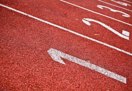 Running Track with White Lane Lines on Red Rubber Surface