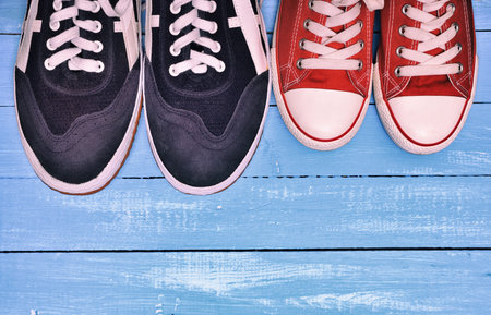 Casual Sneakers on Blue Wooden Background