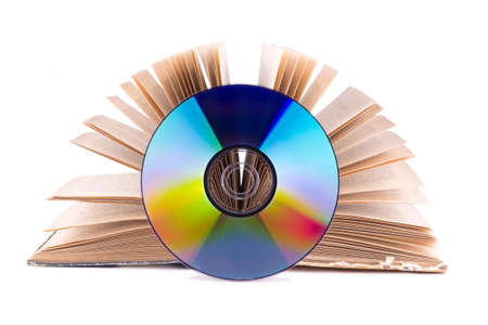Compact disc on an open book isolated on whiteの写真素材