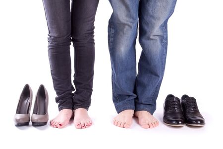 Man and a woman barefoot around their shoes isolated