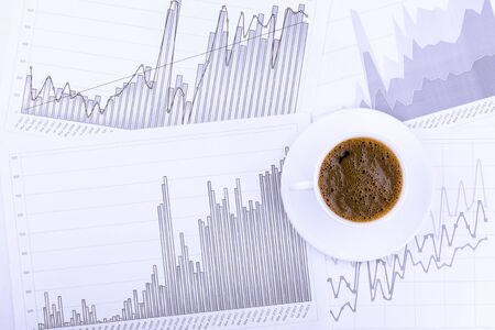 A cup of coffee on the graphs view topの写真素材