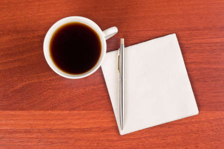 Cup of coffee and napkin on tableの写真素材