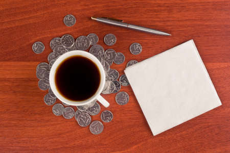 Cup of coffee and napkin on tableの写真素材