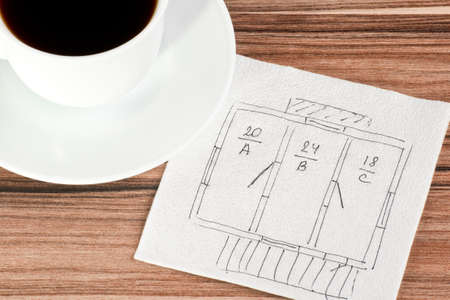 Plan house on a napkin and cup of coffeeの写真素材