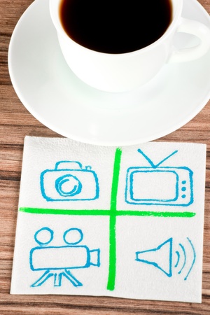 Signs of TV and photo on a napkin and cup of coffeeの写真素材