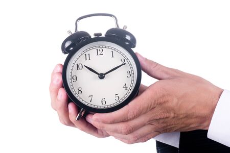 Hands of men holding alarm clock isolatedの写真素材