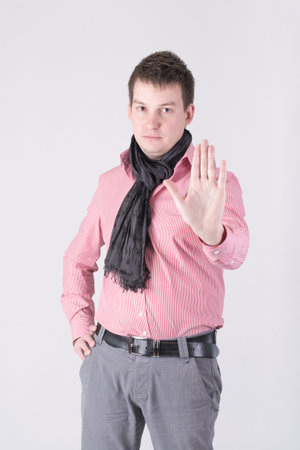 A man in a red shirt showing stop signの写真素材