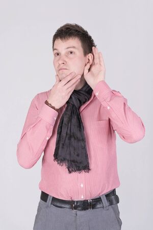 A man in a red shirt listeningの写真素材