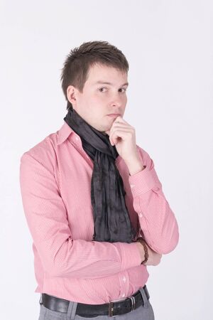 A man in a red shirt thinkingの写真素材