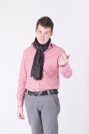 A man in a red shirt beckons fingerの写真素材