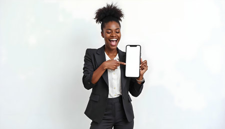 Cheerful african american businesswoman showing smartphone with blank screenの素材